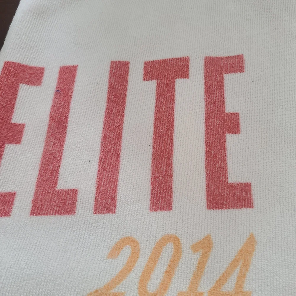 Elite 2014 White Beach Towel with Red and Yellow Icons